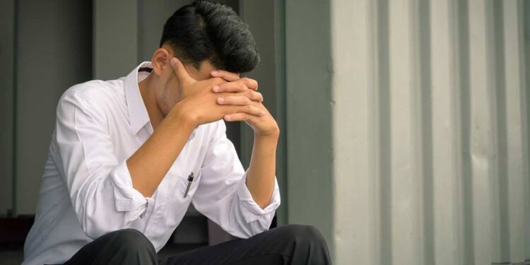 worried businessman sitting after losing job, stressed concept